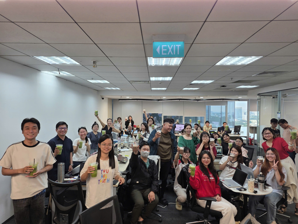 Office team cheering with drinks